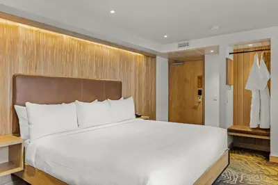 a bedroom with a large white bed and a closet at Otter Hotel in Banff