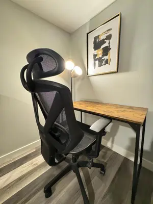 a black office chair sitting in front of a desk at Modern 2 bedroom suite in Calgary