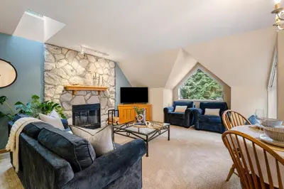 a living room with a couch and a fireplace at 31 GlenEagle in Whistler