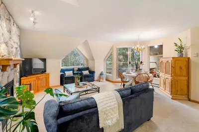 a living room with a couch and a tv at 31 GlenEagle in Whistler