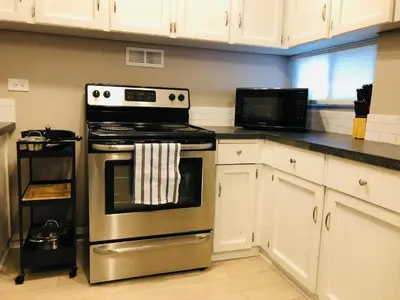a kitchen with a stove and a microwave at 6th Floor 2 Bedroom Condo with Parking in Calgary