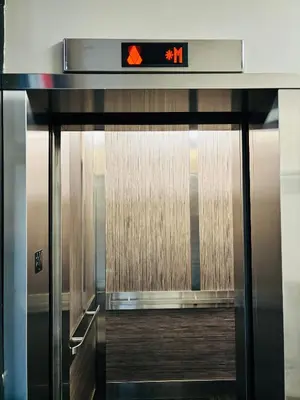 an elevator door with a sign on top of it at 6th Floor 2 Bedroom Condo with Parking in Calgary