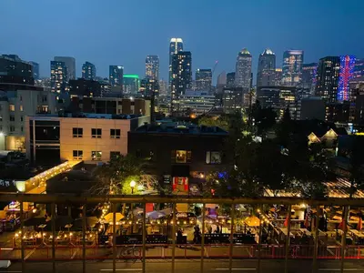 a view of a city skyline at night at 5th Floor Cozy 1 Bedroom Condo with Parking in Calgary