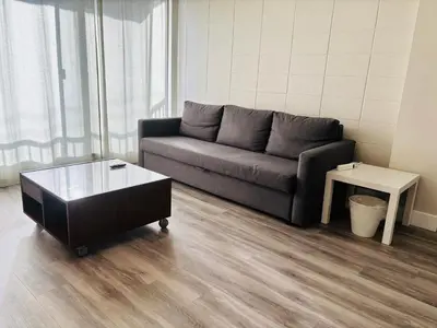 a living room with a couch and a coffee table at Cozy 1 Bedroom Condo with Parking in Calgary