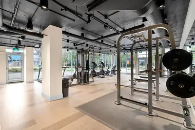 a gym with several treadmills and weights at Brand new Stylists Richmond central 2B2BR in Richmond
