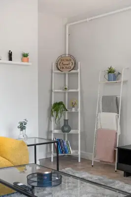 a living room with a table and a shelf at Spacious 4-Bedroom Retreat Near Bow River with Foosball, Dart Board, Movie Room in Calgary
