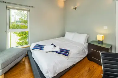 a bedroom with a large bed and a window at NN - The Kit 4 - Downtown 1-Bed 1-Bath in Whitehorse