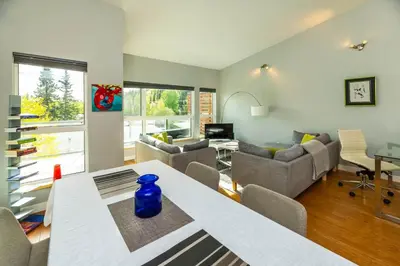 a living room with a table with a blue vase on it at NN - The Kit 4 - Downtown 1-Bed 1-Bath in Whitehorse