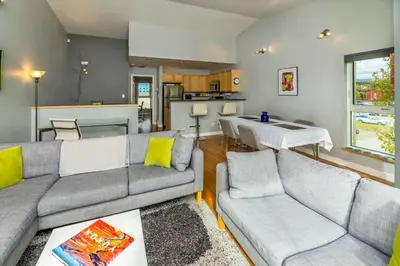 a living room with two couches and a kitchen at NN - The Kit 4 - Downtown 1-Bed 1-Bath in Whitehorse