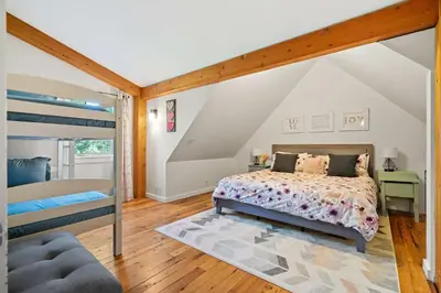 a bedroom with a bed and a bunk bed at Rolling Hills Retreat - Family Friendly in Millarville