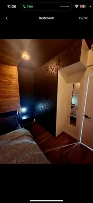 a bedroom with a bed and a room with a mirror at Charming & Compact Retreat in St. Albert
