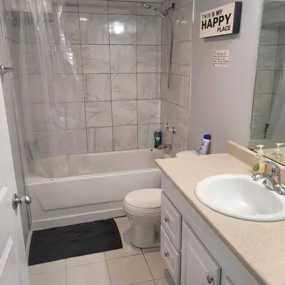 a bathroom with a tub and a toilet and a sink at Fabulous Room in Edmonton