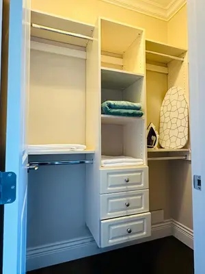 a closet with white cabinets and drawers at \u8212\u9002\u5927\u5e8a\u5957\u623f in Richmond