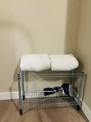 a towel rack with two towels on top of it at Walkout Basement Suite with Free Street Parking in Calgary