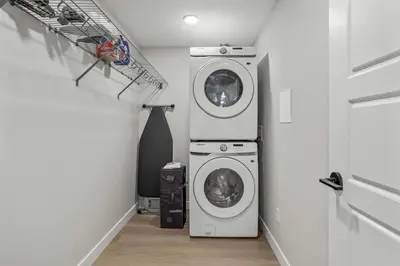 a laundry room with a washer and a washing machine at Outdoor heated pool and hot tub Stunning 3Bd sanctuary in Dead Man's Flats