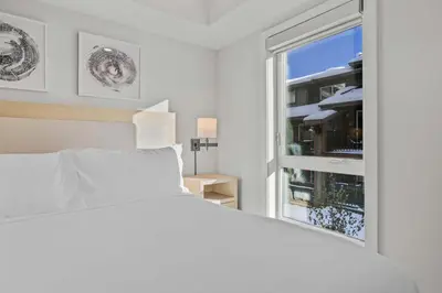 a white bedroom with a bed and a window at Outdoor heated pool and hot tub Stunning 3Bd sanctuary in Dead Man's Flats
