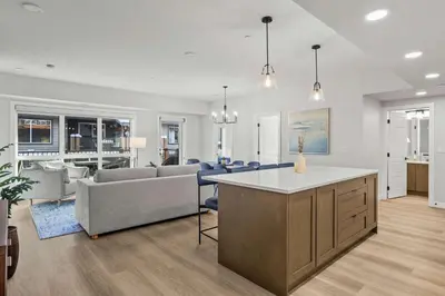 a kitchen and living room with a couch and a table at Outdoor heated pool and hot tub Stunning 3Bd sanctuary in Dead Man's Flats