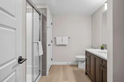 a white bathroom with a toilet and a shower at Pool and hot tub Stunning 2Bd haven in the Rockies in Dead Man's Flats