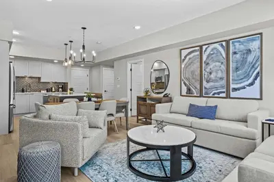 a living room with two couches and a table at Pool and hot tub Stunning 2Bd haven in the Rockies in Dead Man's Flats