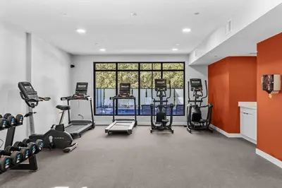 a gym with several treadmills and cardio machines at Pool and hot tub Stunning 2Bd haven in the Rockies in Dead Man's Flats