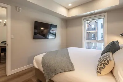 a bedroom with a large bed and a window at La Sombra at Sparrowhawk Lodge Brand New 2Bd in Dead Man's Flats