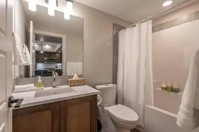 a bathroom with a sink and a toilet and a shower at La Sombra at Sparrowhawk Lodge Brand New 2Bd in Dead Man's Flats