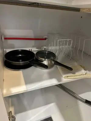 a stove with a pot and a pan on it at The Urban Nest in Calgary