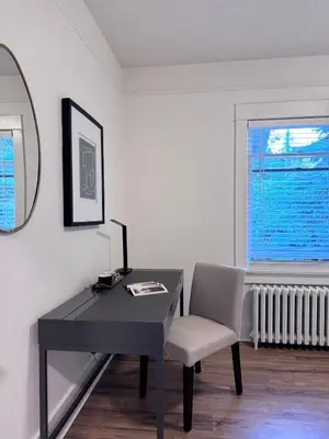 a desk with a chair and a mirror and a window at Deluxe Queen Room Private Ensuite Vancouver West in Vancouver