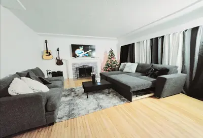 a living room with a couch and a fireplace at Spacious Private Cozy 2br Home with TeePee Dining Room! Private Parking! Self Check-in in Burnaby