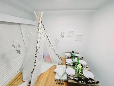 a room with a table with a iguana tent at Spacious Private Cozy 2br Home with TeePee Dining Room! Private Parking! Self Check-in in Burnaby