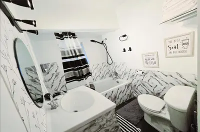 a white bathroom with a sink and a toilet at Spacious Private Cozy 2br Home with TeePee Dining Room! Private Parking! Self Check-in in Burnaby