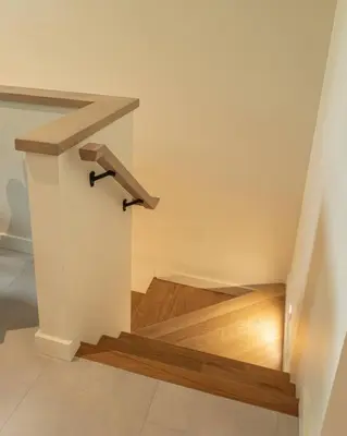 a staircase with a wooden stair railing in a house at Calmwater Retreat New 2 br Hot Tub in Ucluelet
