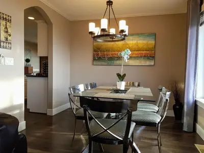 a dining room with a table and chairs at Peachland Lake View Spectacular! in Peachland
