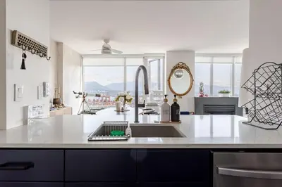 a kitchen with a sink and a large window at Luxury 2 Bed 2 Bath Condo Downtown Vancouver with Free Parking in Vancouver
