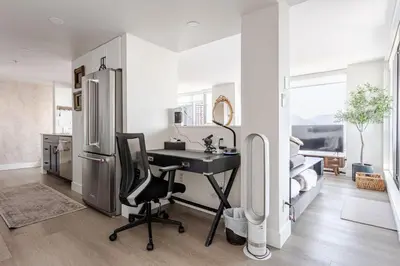 a kitchen with a desk and a refrigerator at Luxury 2 Bed 2 Bath Condo Downtown Vancouver with Free Parking in Vancouver