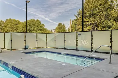 a swimming pool with a fence around it at Perfect 3 bed-2 bath Top Floor Hot Tub Heated Pool Gym in Dead Man's Flats