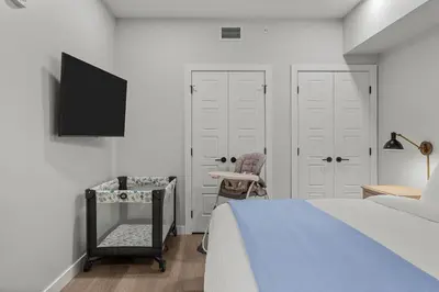 a bedroom with a bed and a desk and a tv at Perfect 3 bed-2 bath Top Floor Hot Tub Heated Pool Gym in Dead Man's Flats