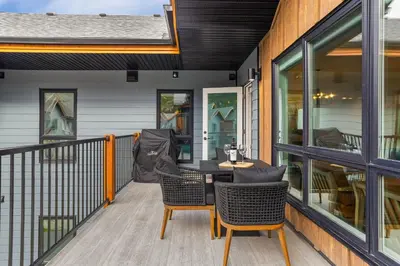a patio with a table and chairs on a balcony at Perfect 3 bed-2 bath Top Floor Hot Tub Heated Pool Gym in Dead Man's Flats