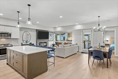 a kitchen and living room with a table and chairs at Perfect 3 bed-2 bath Top Floor Hot Tub Heated Pool Gym in Dead Man's Flats