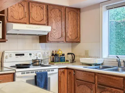 a kitchen with a white stove and a sink at Garden Hotel 3-bedroom house for whole book in Richmond