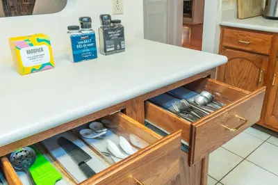 a kitchen counter with a drawer with silver utensils at Garden Hotel 3-bedroom house for whole book in Richmond