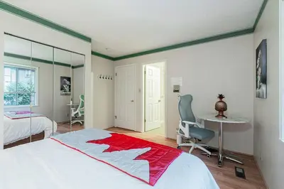 a bedroom with a bed and a desk and a chair at Garden Hotel 3-bedroom house for whole book in Richmond