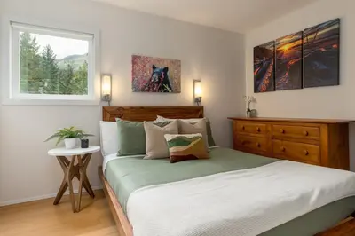 a bedroom with a large bed and a window at 1BR in Gondola Village, Near Gondola, Free Parking, Updated Unit, Incredible Location in Whistler