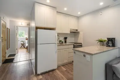 a kitchen with white cabinets and a white refrigerator at 1BR in Gondola Village, Near Gondola, Free Parking, Updated Unit, Incredible Location in Whistler