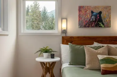 a bedroom with a bed and a picture of a bear at 1BR in Gondola Village, Near Gondola, Free Parking, Updated Unit, Incredible Location in Whistler