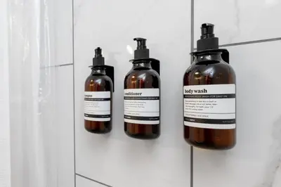 three bottles of alcohol are on a wall at BunkBedDreams,10 Beds,Near Rogers place and Nait in Edmonton