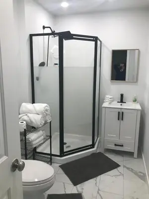 a bathroom with a shower and a toilet and a sink at Northern Rainbow Upper Level Suite in House in Yellowknife