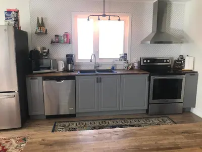 a kitchen with stainless steel appliances and a window at Northern Rainbow Upper Level Suite in House in Yellowknife