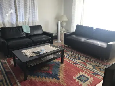 a living room with a couch and a coffee table at Northern Rainbow Upper Level Suite in House in Yellowknife