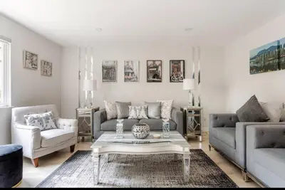 a living room with two couches and a coffee table at The Oxford Signature Luxury Entire Family Suite in Coquitlam